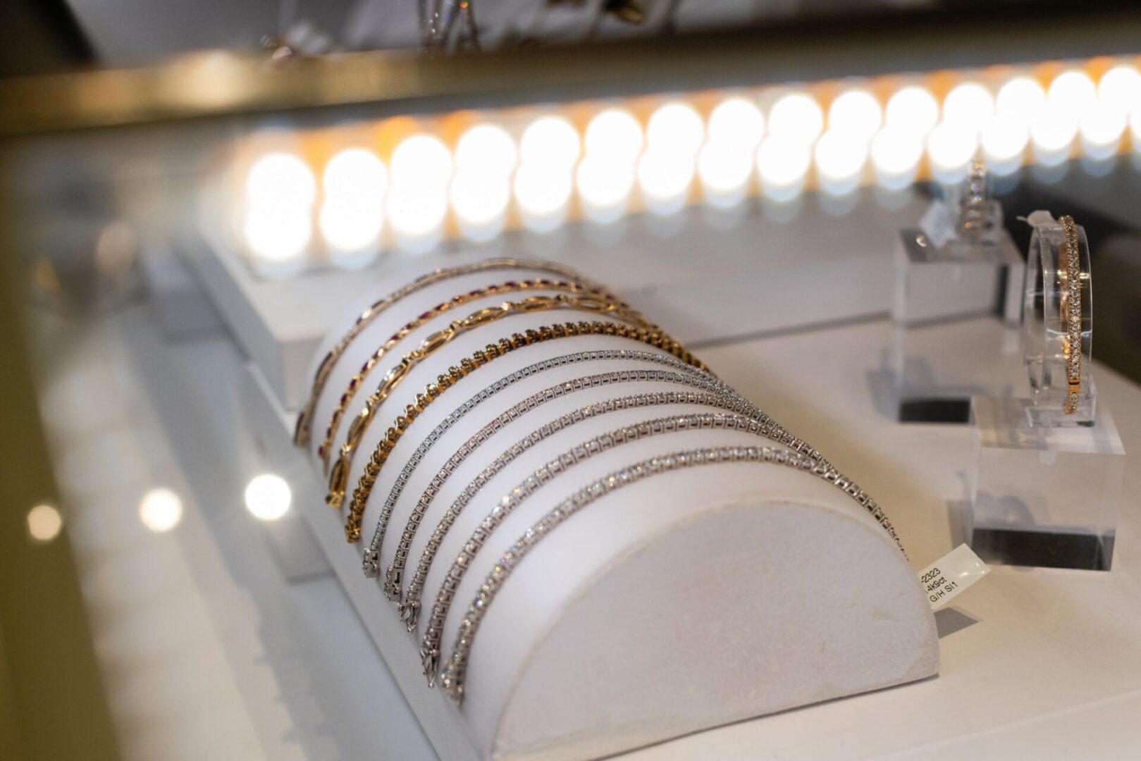 A row of white bracelets sitting on top of a table.